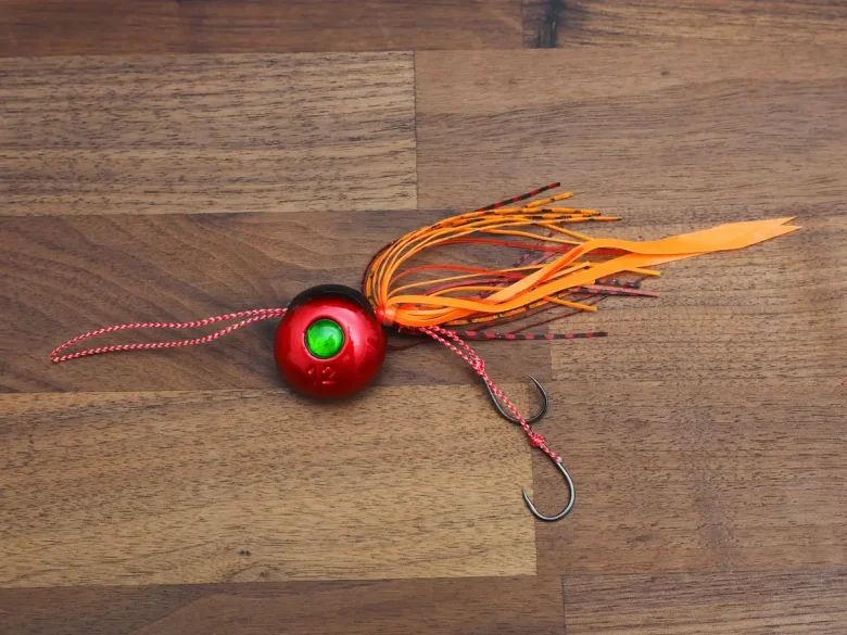 Orange tairaba head and skirt on a wooden board
