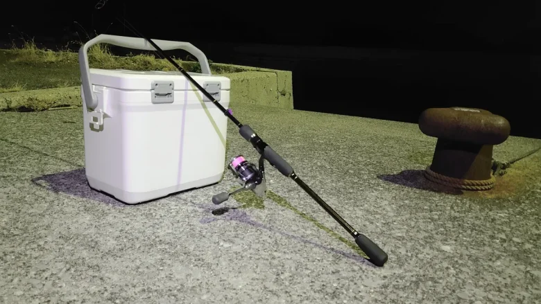Cooler box and ajing tackle on a breakwater at night