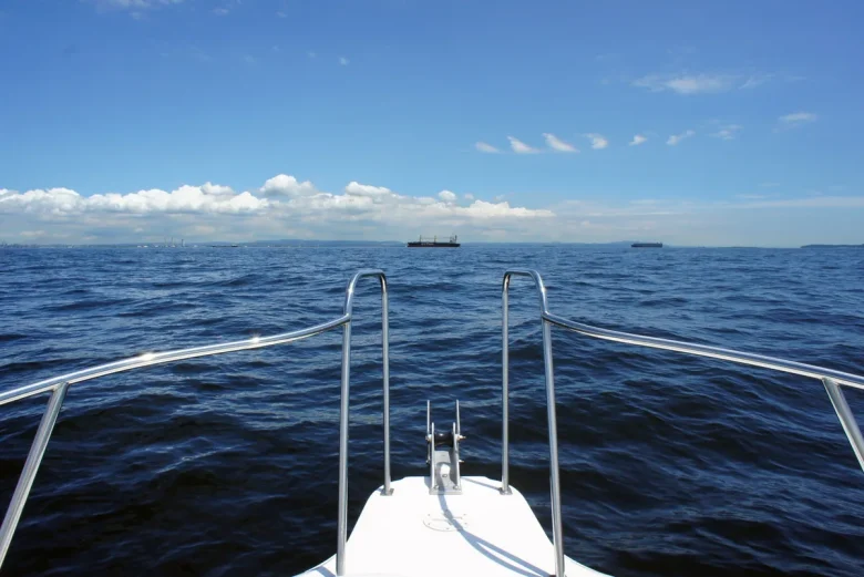 View over the bow rail of a boat toward the horizon